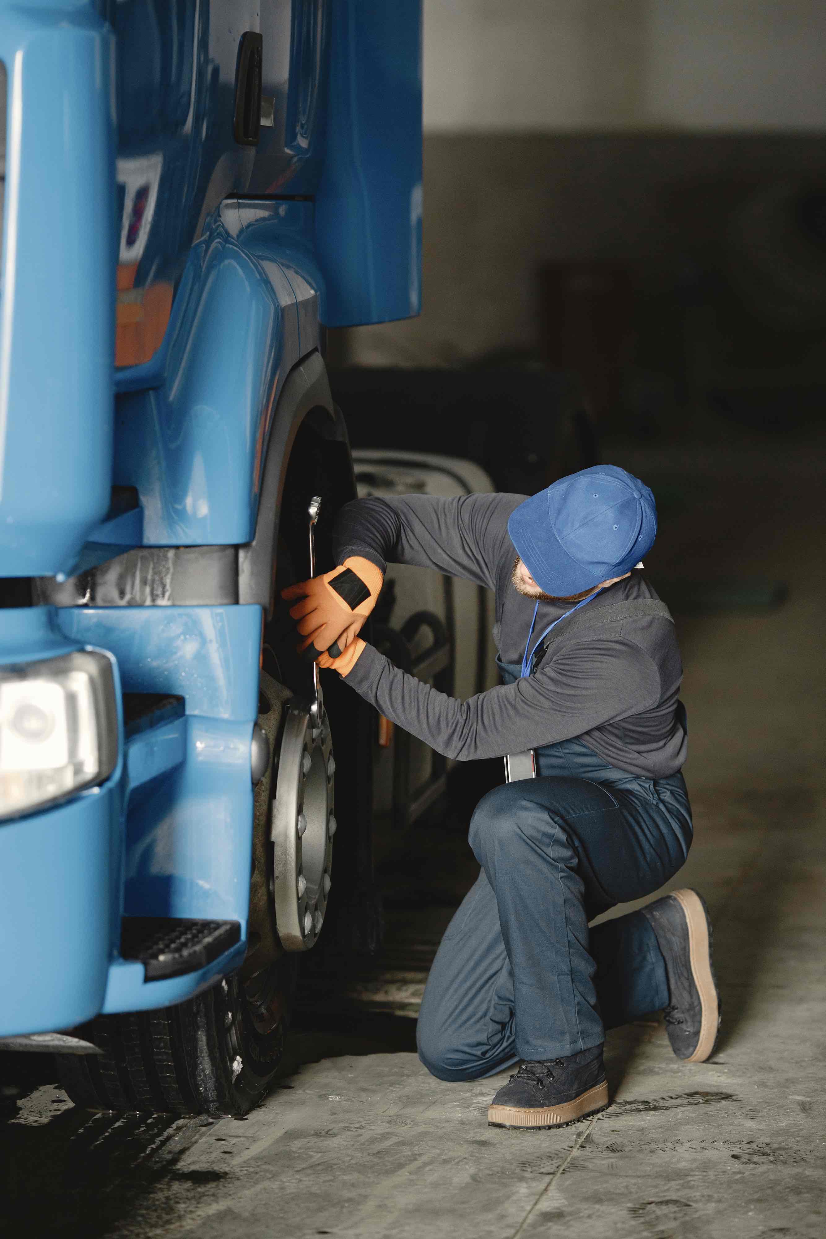 young worker checks wheel truck malfunction service work